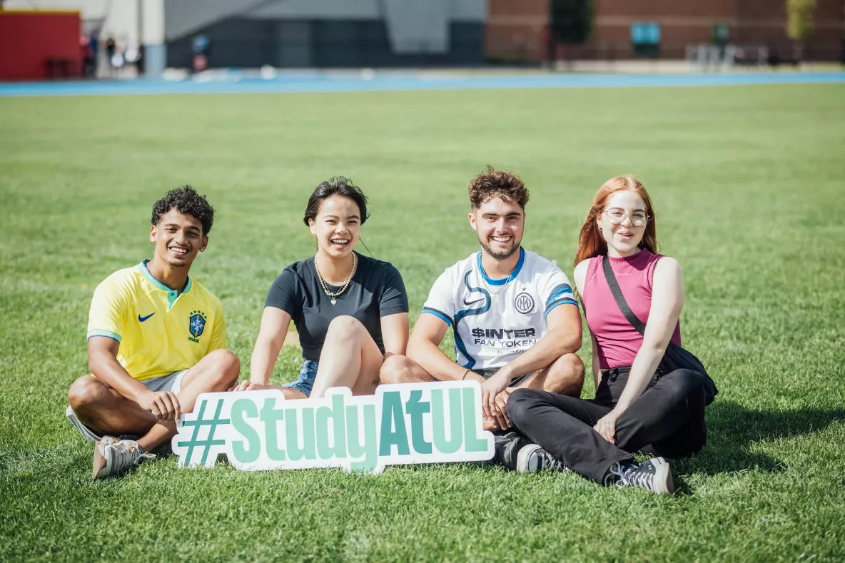 Students holding a #StudyatUL sign before the Speed friending event in September 23 orientation