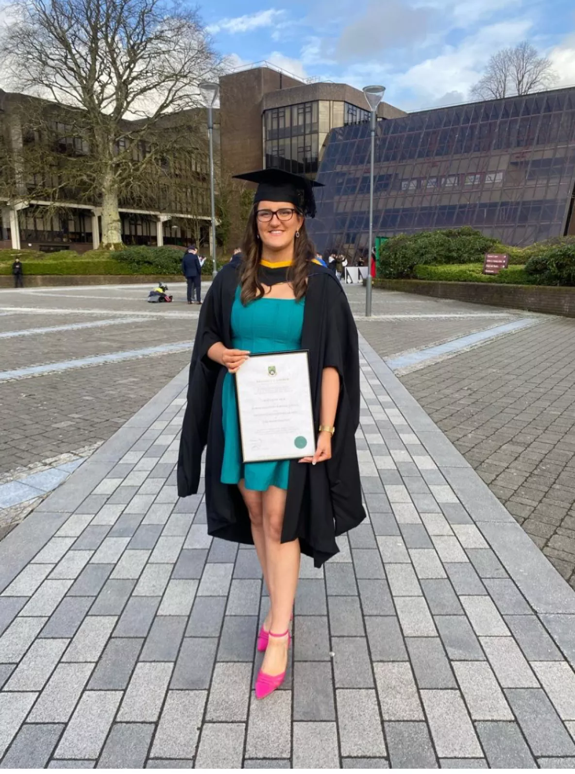 edel kearney, masters graduate, holding her parchment