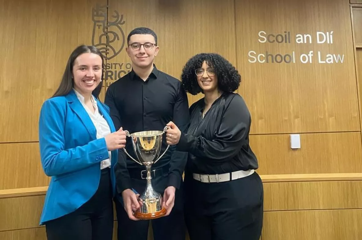 Emma Wright, Adham Mahdy and Wiame Kanane, winners, holding the trophy