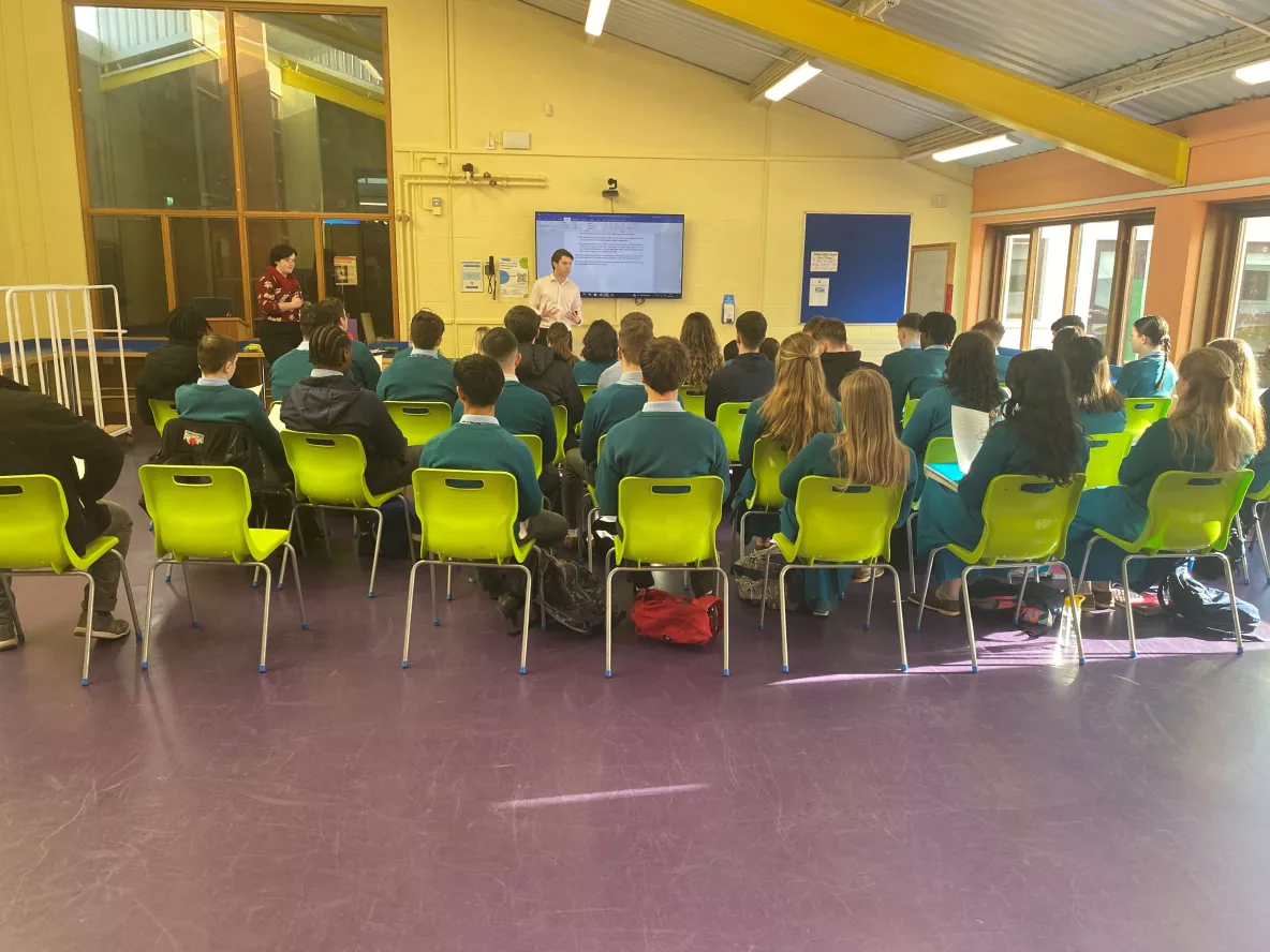 dr luke danagher and administrator kathleen coll speaking to a group of students in the library of castletroy college