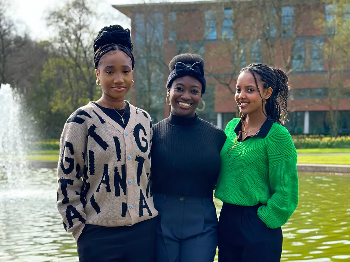 Three women standing in front of a fountain on the University of Limerick campus