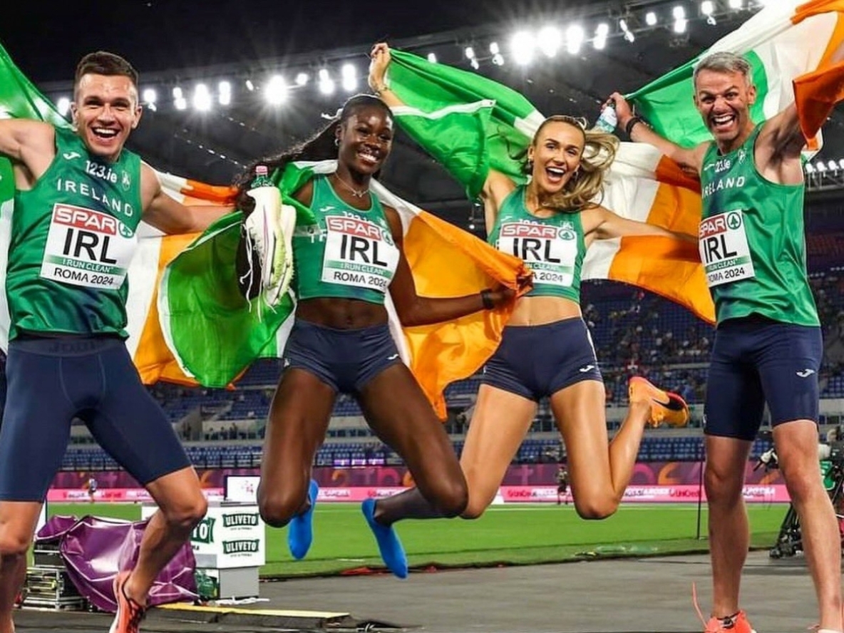 European gold medalists in the 4x400 mixed relay celebrating their win wrapped in Irish flags
