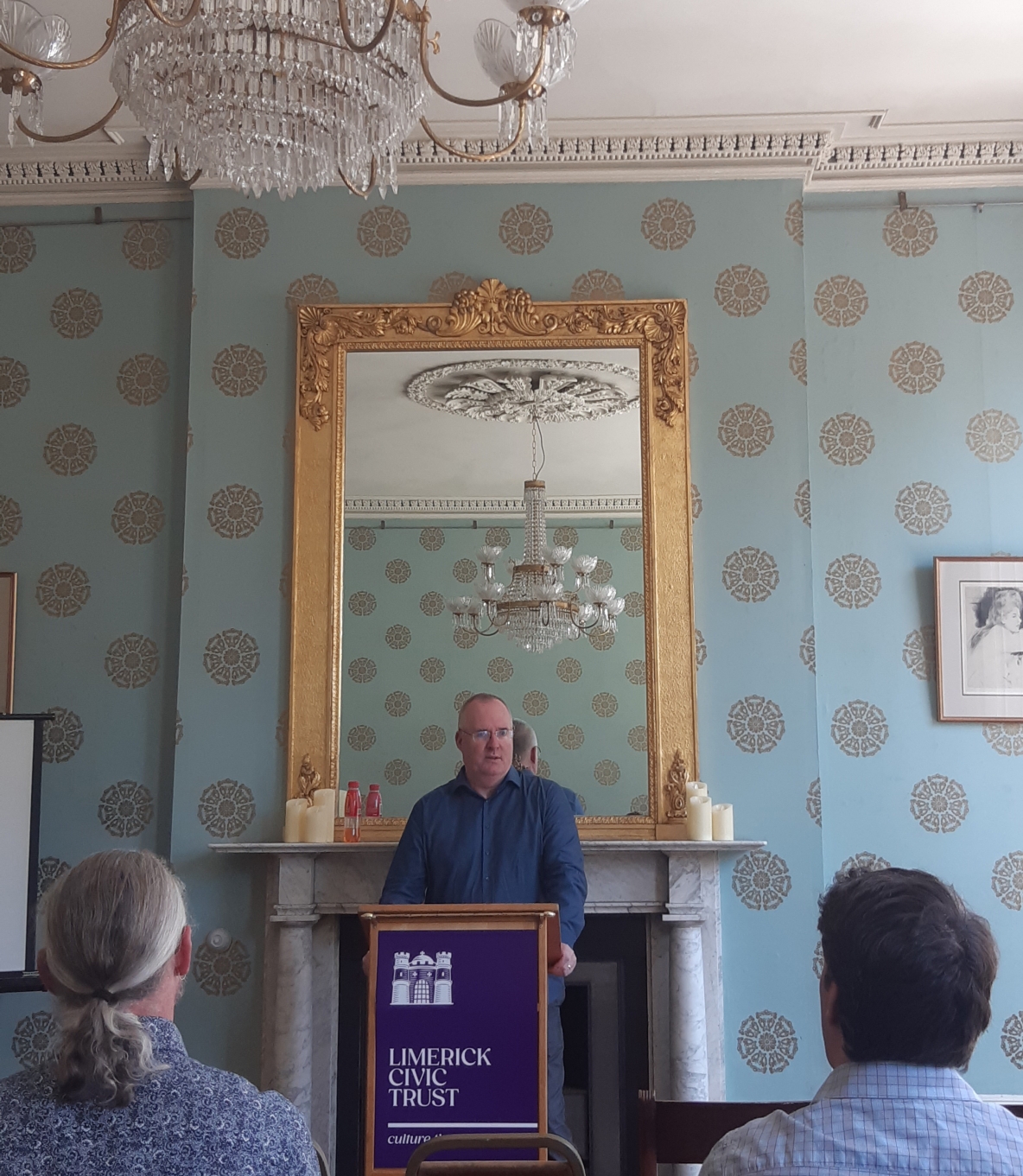 a man standing at the podium speaking at a limerick civic trust event