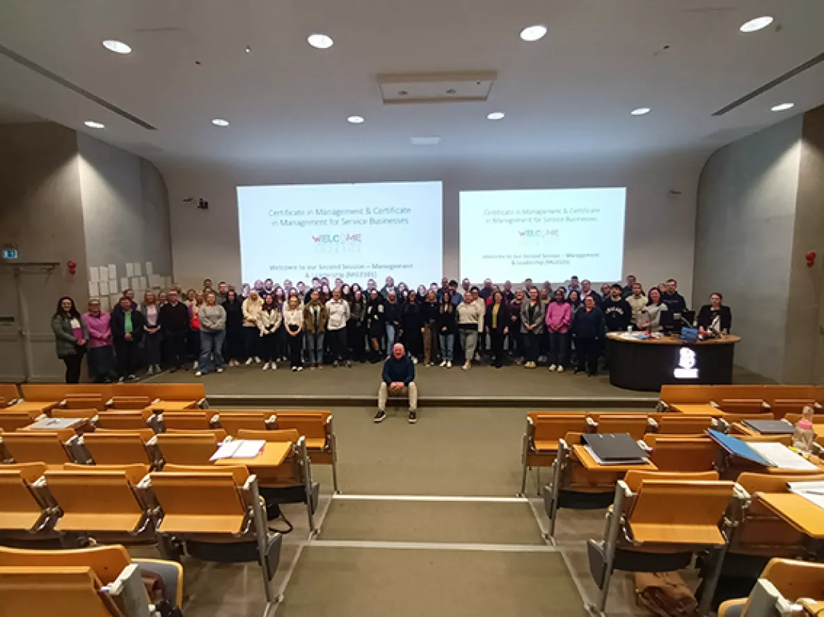 a large group of new Management Pathway students pictured in a lecture hall