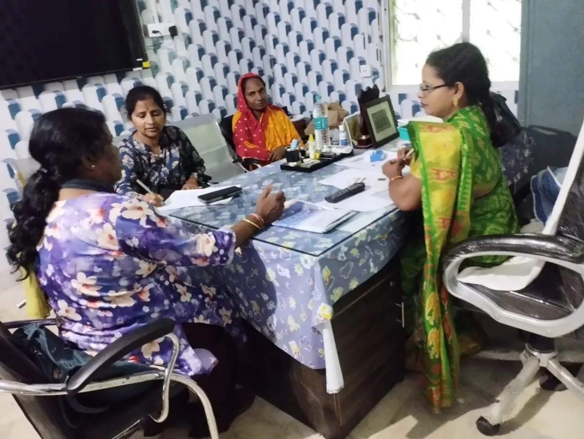 Nita meets with women around a table having a discussion