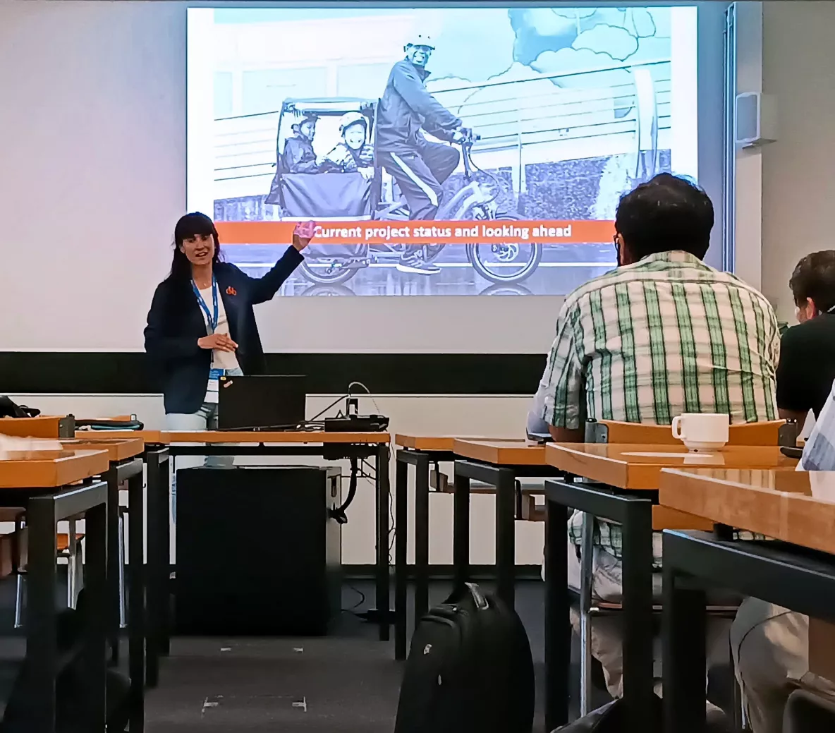 Dr. Anna Barrero presenting in front of a crowd of people.