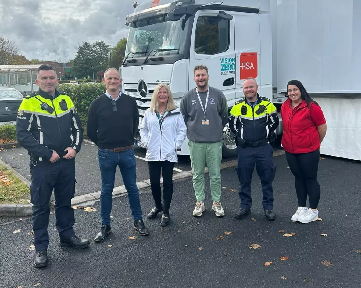 Six people standing outside the Road Safety Authority Interactive Shuttle Bus on the UL campus - two of them are Gardai in uniform