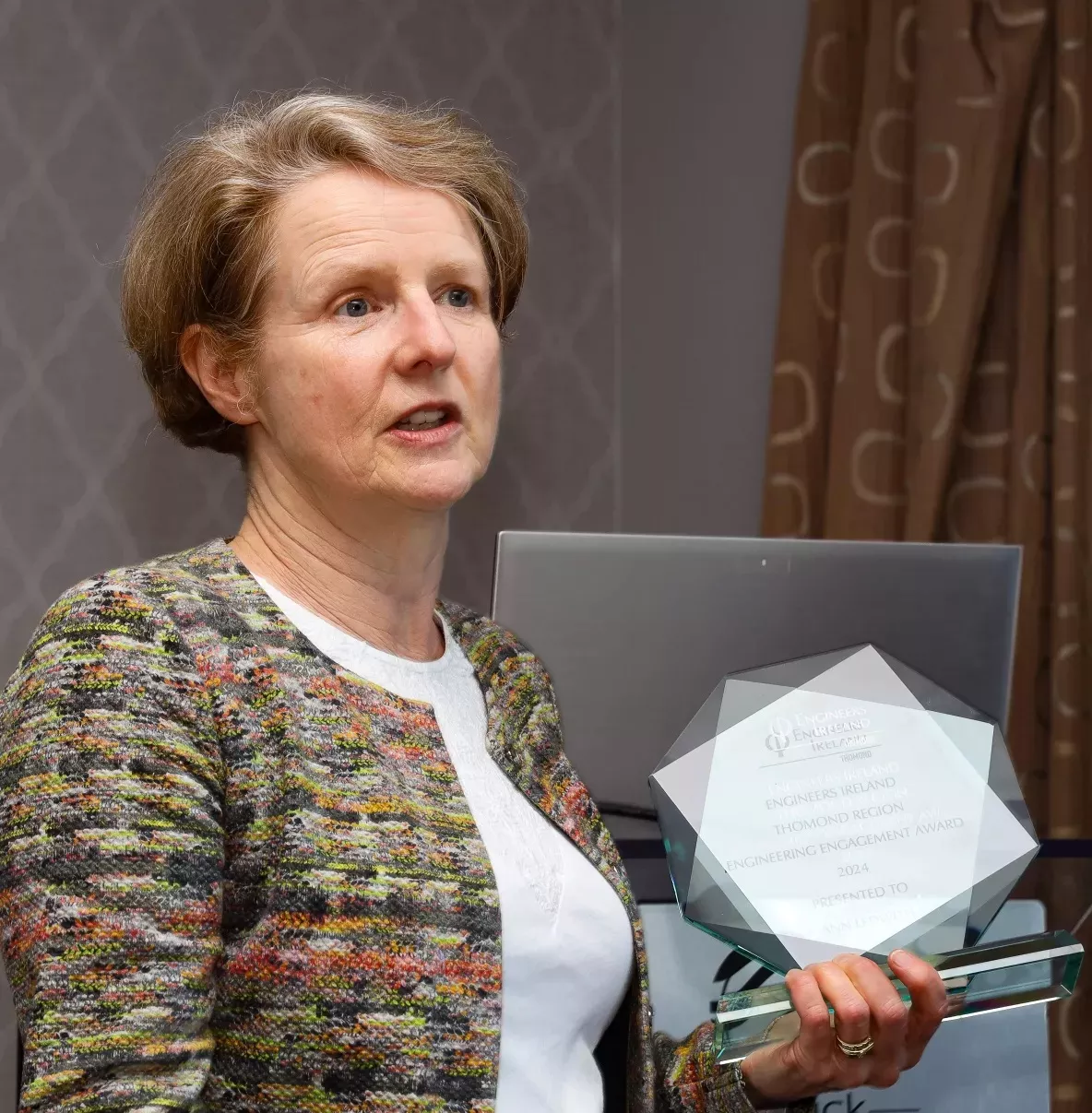 A picture of Professor Ann Ledwith, holding an award