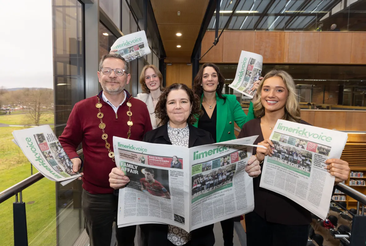 A group holding newspapers at the launch of the Limerick Voice in the UL library