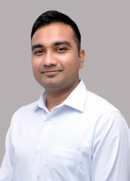 A man wearing a white shirt smiling 