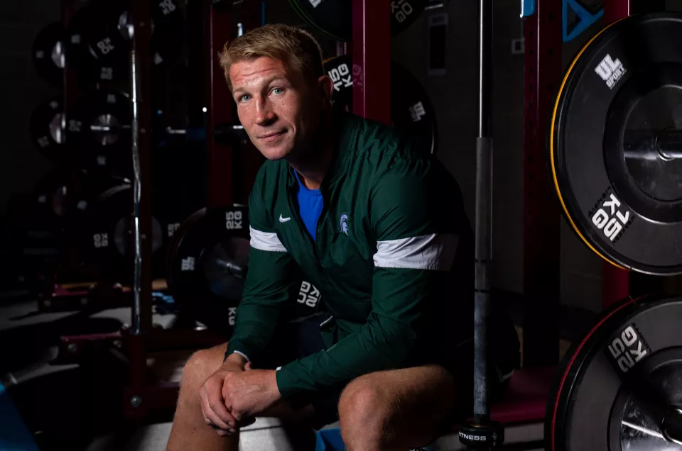 Jerry Flannery sitting in a gym