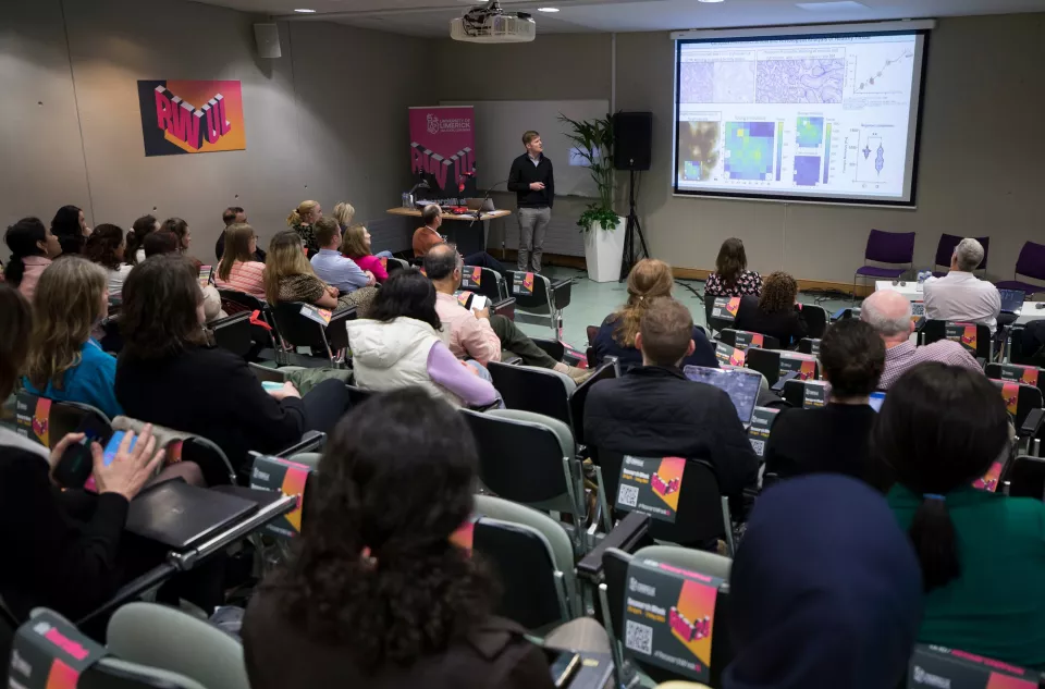 A presentation being given in a busy lecture theatre