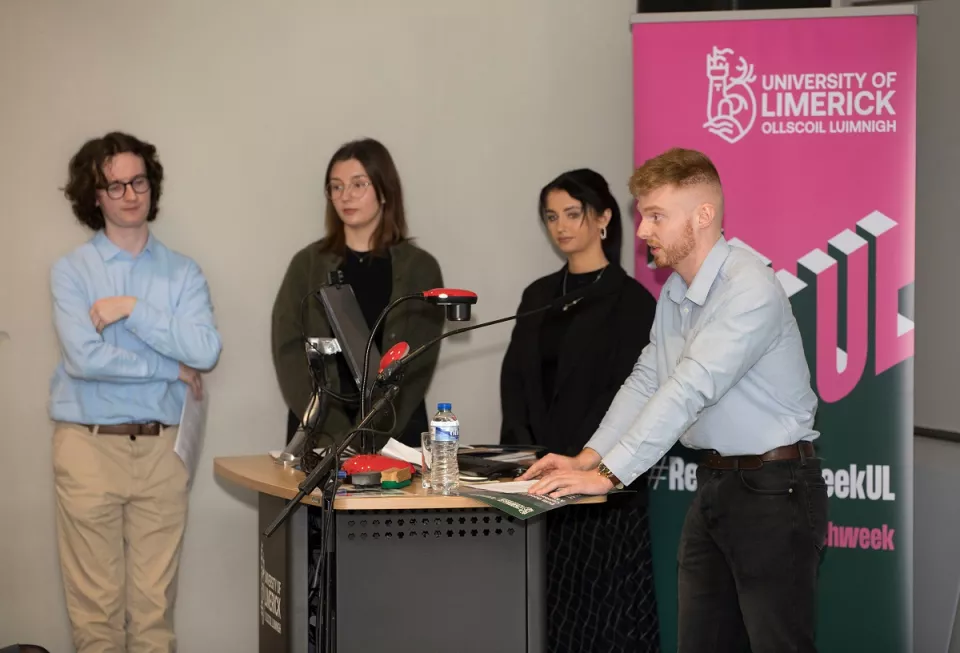 A group of people speaking from a podium