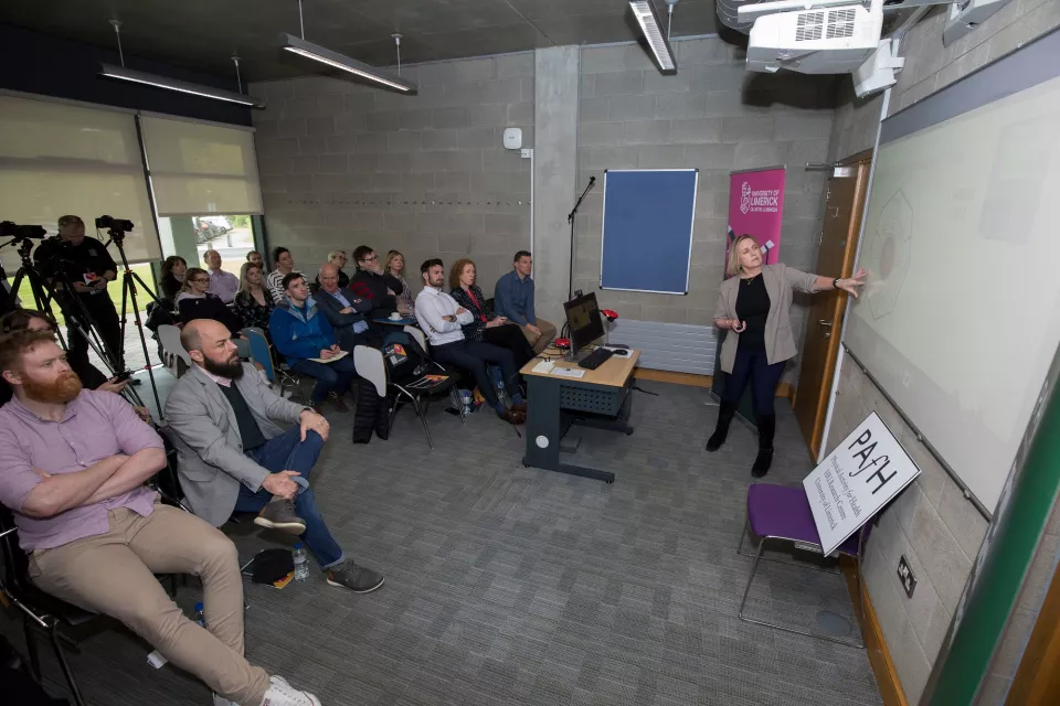 A woman giving a presentation to a roomful of people