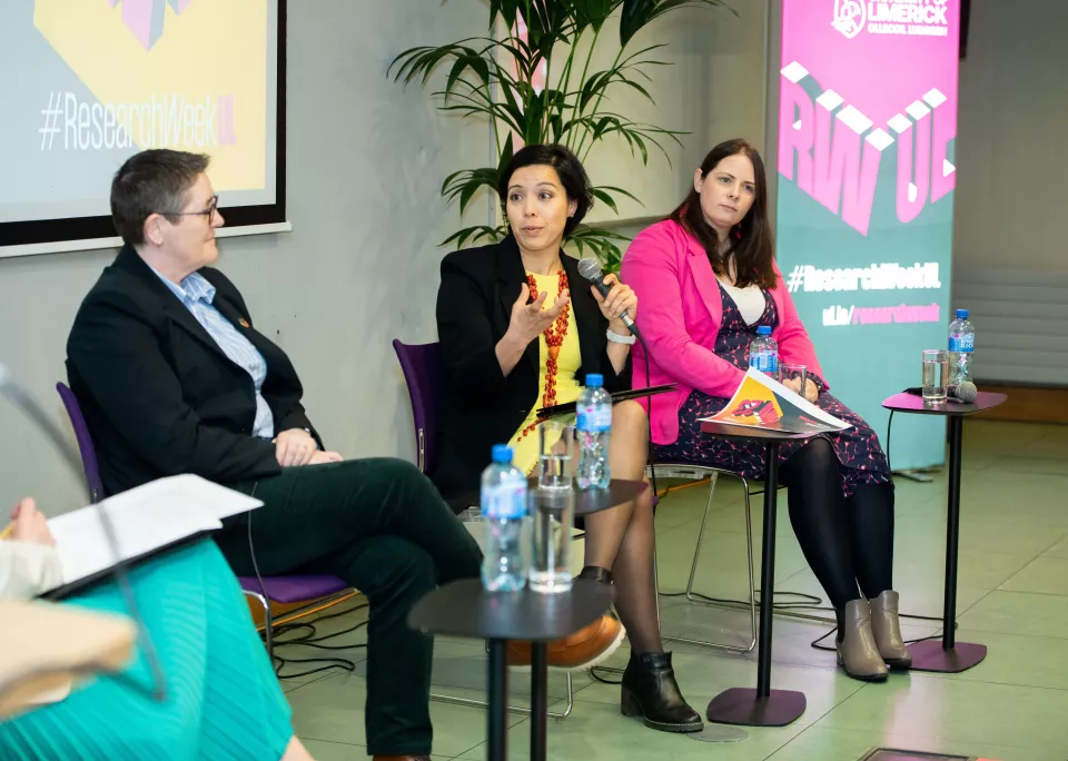 Discussion between three women who are seated in from of a screen