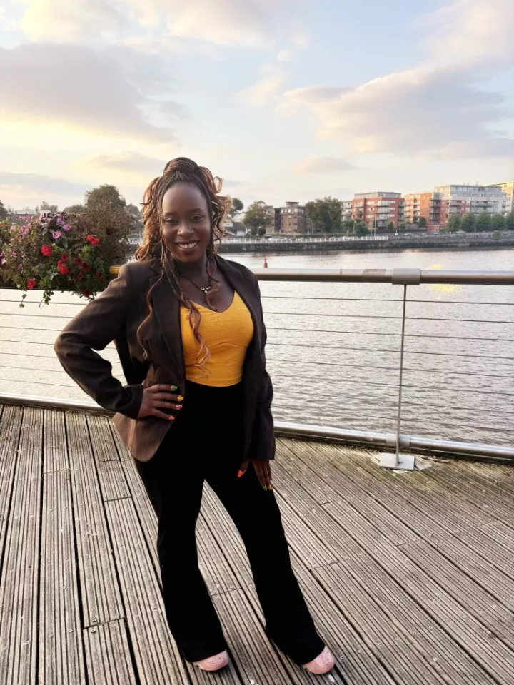 woman standing on boardwalk by river